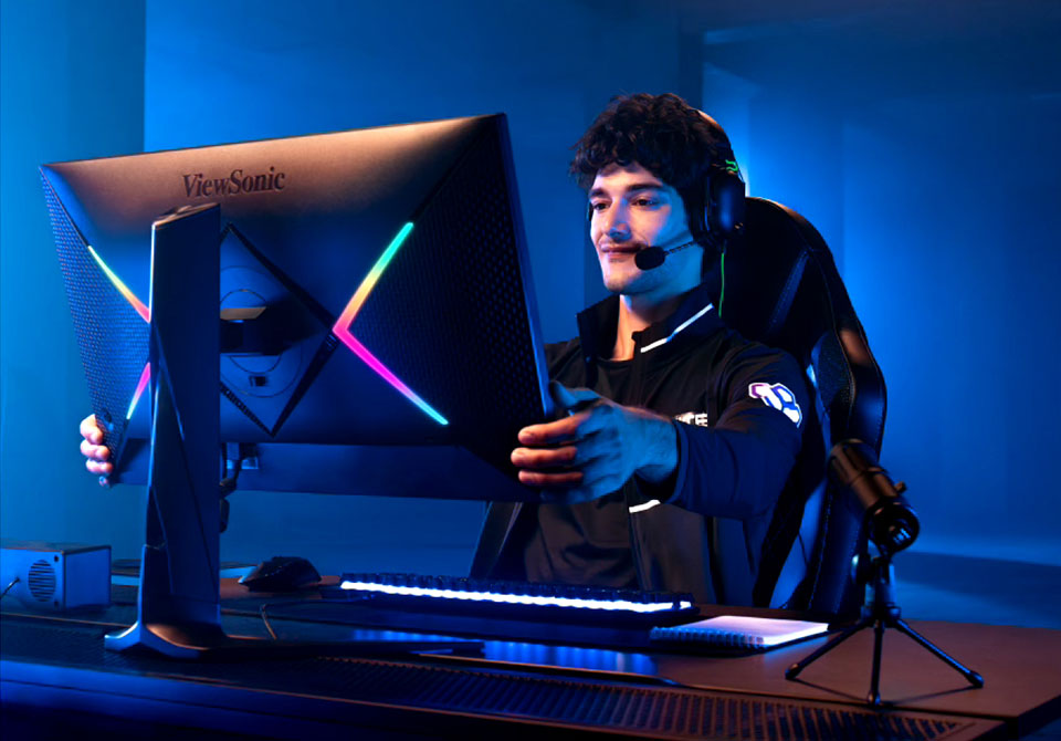 Joueur professionnel ajustant un moniteur gaming ViewSonic.