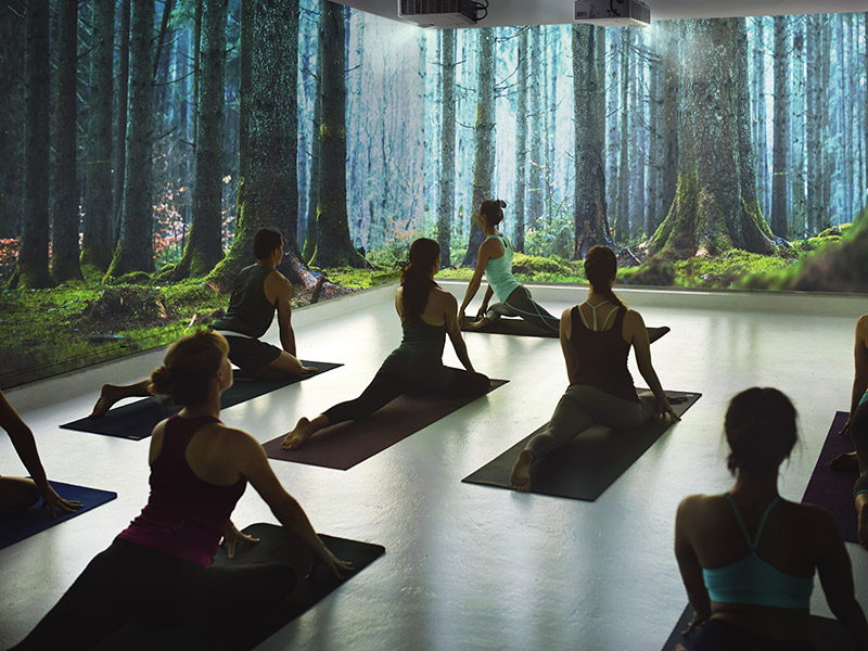 Ultra-short throw projector displaying clear visuals for a yoga session.